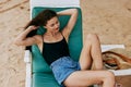 beach woman resort holiday lifestyle ocean sea sand smiling lying sunbed Royalty Free Stock Photo