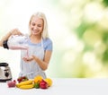 Smiling woman with blender and fruit milk shake Royalty Free Stock Photo