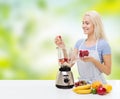 Smiling woman with blender preparing shake at home Royalty Free Stock Photo