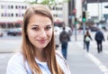 Smiling woman with blond hair in the city