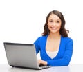 Smiling woman in blue clothes with laptop computer Royalty Free Stock Photo