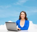 Smiling woman in blue clothes with laptop computer Royalty Free Stock Photo