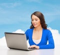 Smiling woman in blue clothes with laptop computer Royalty Free Stock Photo
