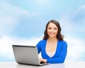 Smiling woman in blue clothes with laptop computer Royalty Free Stock Photo