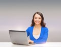 Smiling woman in blue clothes with laptop computer Royalty Free Stock Photo