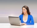 Smiling woman in blue clothes with laptop computer Royalty Free Stock Photo