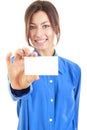 Smiling woman in blue shirt holds out a business or credit card Royalty Free Stock Photo