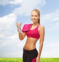 Smiling woman with bottle of water and towel Royalty Free Stock Photo