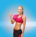 Smiling woman with bottle of water and towel Royalty Free Stock Photo