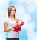 Smiling woman with bouquet of flowers and gift box Royalty Free Stock Photo