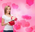 Smiling woman with bouquet of flowers and gift box Royalty Free Stock Photo