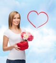 Smiling woman with bouquet of flowers and gift box Royalty Free Stock Photo