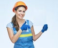 Smiling woman builder holding white sign board with thumb up.