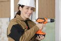 smiling woman builder worker with drill