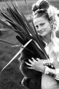 Smiling woman with a bulrush grass reed on rural field, monochrome