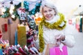 Smiling woman is buying Christmas flowers for ornamentals