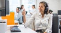 Smiling woman call center operator in headset showing thumbs up gesture to customer in video call Royalty Free Stock Photo
