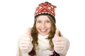 Smiling woman with cap and scarf shows both thumbs