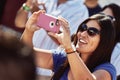 Smiling Woman Captures The Moment on her Cell Phone Royalty Free Stock Photo