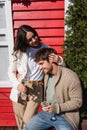 Smiling woman in cardigan hugging boyfriend Royalty Free Stock Photo