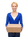 Smiling woman in casual clothes with parcel box Royalty Free Stock Photo