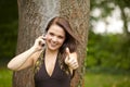 Smiling woman with cell phone posing thumbs up Royalty Free Stock Photo