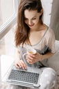 Smiling woman chatting on laptop in the morning Royalty Free Stock Photo