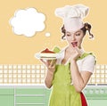 Smiling woman chef holding sweet cheesecake in hand. Royalty Free Stock Photo