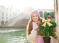 Smiling woman with Christmas tree near Rialto Bridge in Venice Royalty Free Stock Photo