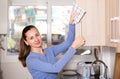 Smiling woman is cleaning surface on the kitchen at the home Royalty Free Stock Photo