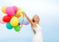 Smiling woman with colorful balloons outside Royalty Free Stock Photo