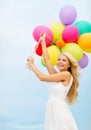 Smiling woman with colorful balloons outside Royalty Free Stock Photo