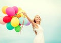 Smiling woman with colorful balloons outside Royalty Free Stock Photo