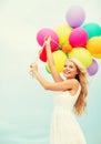 Smiling woman with colorful balloons outside Royalty Free Stock Photo