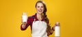 Smiling woman cook giving glass of homemade fresh raw milk Royalty Free Stock Photo