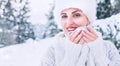 Smiling woman in cozy knitwear and fur hat with cup of hot drink Royalty Free Stock Photo