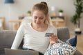 Smiling woman with credit card in hand using laptop, shopping online Royalty Free Stock Photo