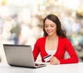 Smiling woman with credit card and laptop Royalty Free Stock Photo
