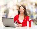 Smiling woman with credit card and laptop Royalty Free Stock Photo