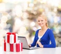 Smiling woman with credit card and laptop Royalty Free Stock Photo