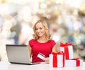 Smiling woman with credit card and laptop Royalty Free Stock Photo