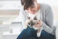 Smiling woman cuddling her cat Royalty Free Stock Photo