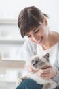 Smiling woman cuddling her cat Royalty Free Stock Photo