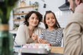 Smiling woman and daughter looking at Royalty Free Stock Photo