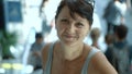 Smiling woman descends on an escalator