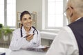 Smiling woman doctor consult old male patient Royalty Free Stock Photo