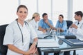 Smiling woman doctor looking at the camera in front of her team Royalty Free Stock Photo