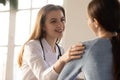 Smiling woman doctor sharing good news with happy female patient