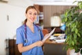 Smiling woman doctor standing in office with papers in hands Royalty Free Stock Photo
