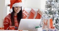 Smiling woman doing online Christmas shopping Royalty Free Stock Photo